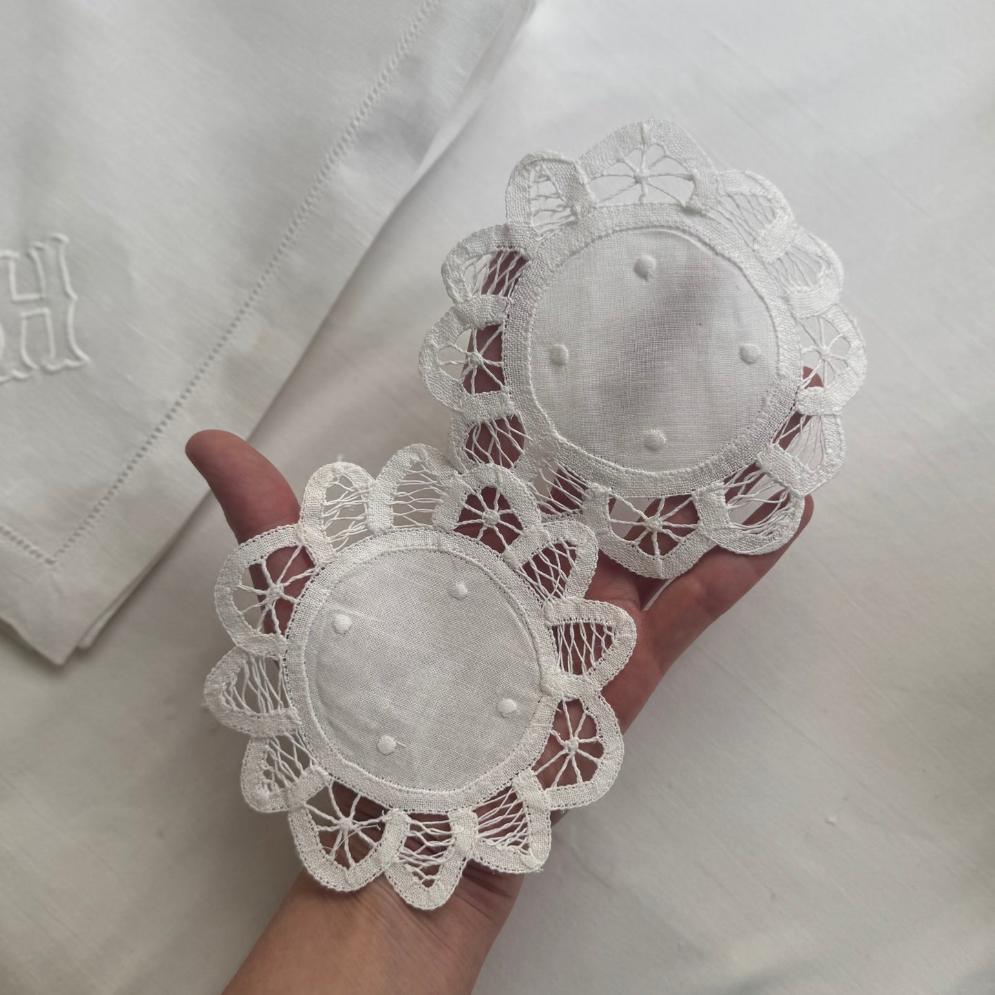 White lace doilies held in a hand