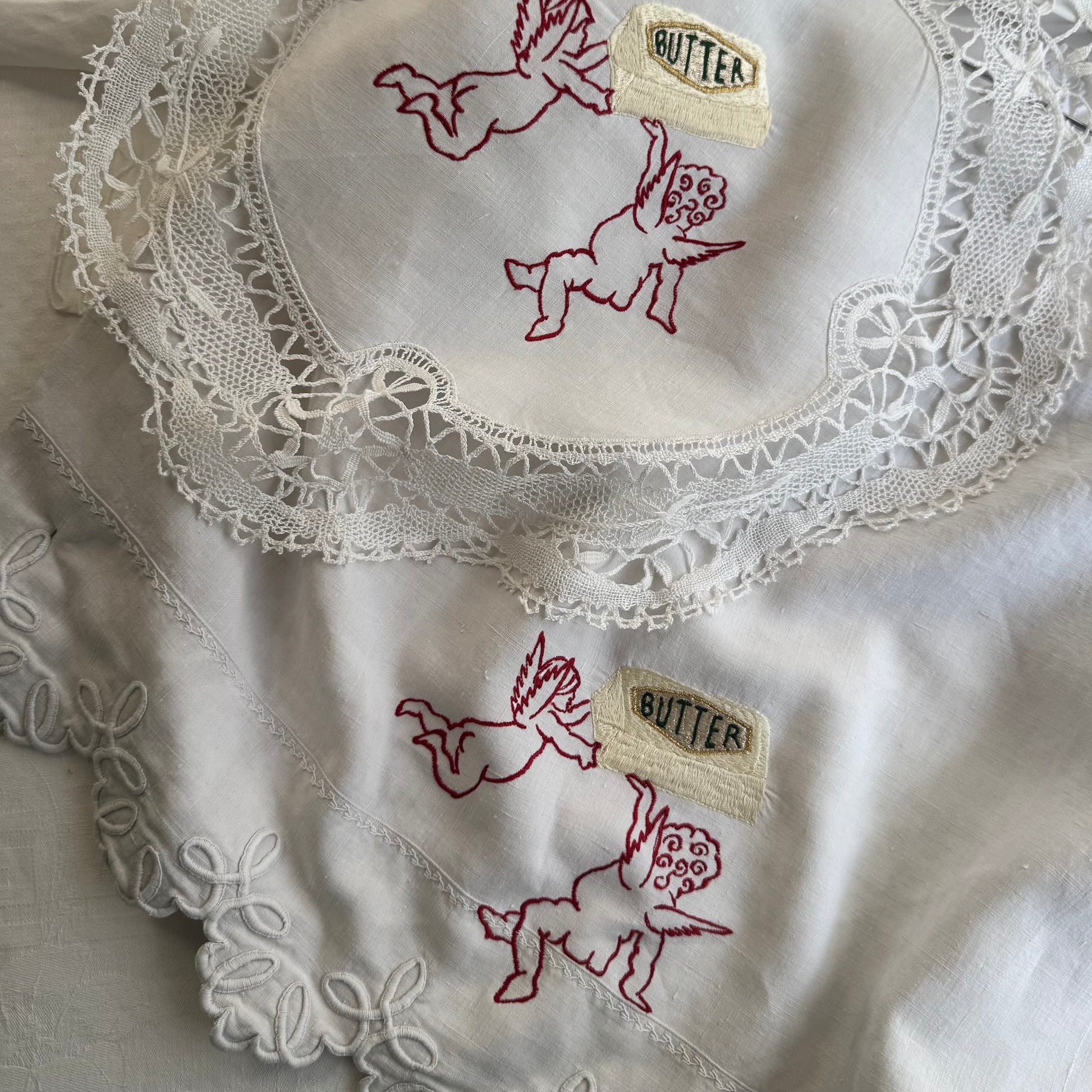 Two bespoke linen butter babies artwork orders, both on white vintage antique linens.