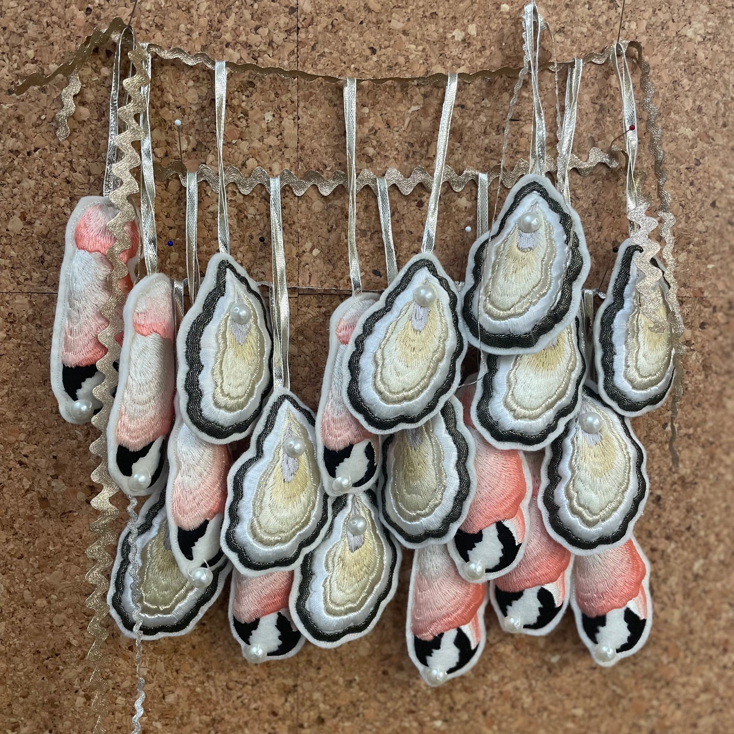 Hanging embroidered decorations on cork board