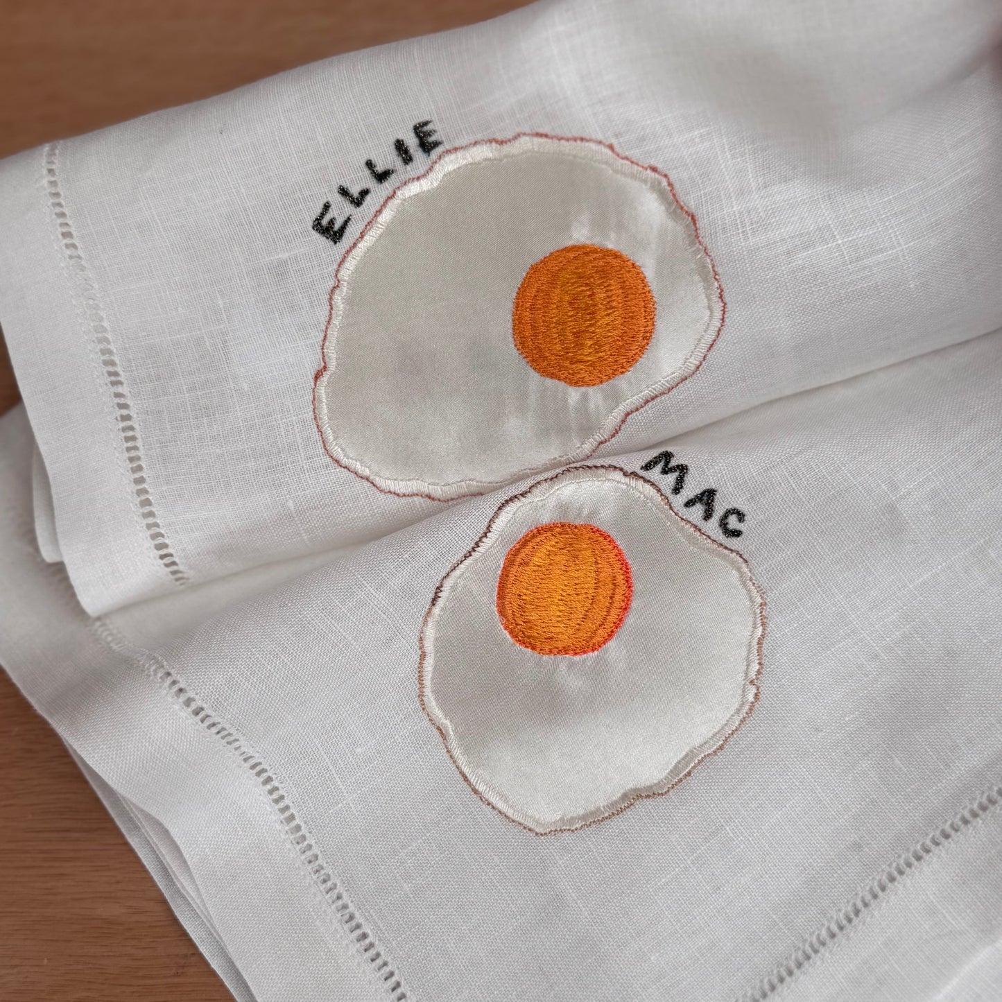 Close-up of fried egg napkins on wooden table