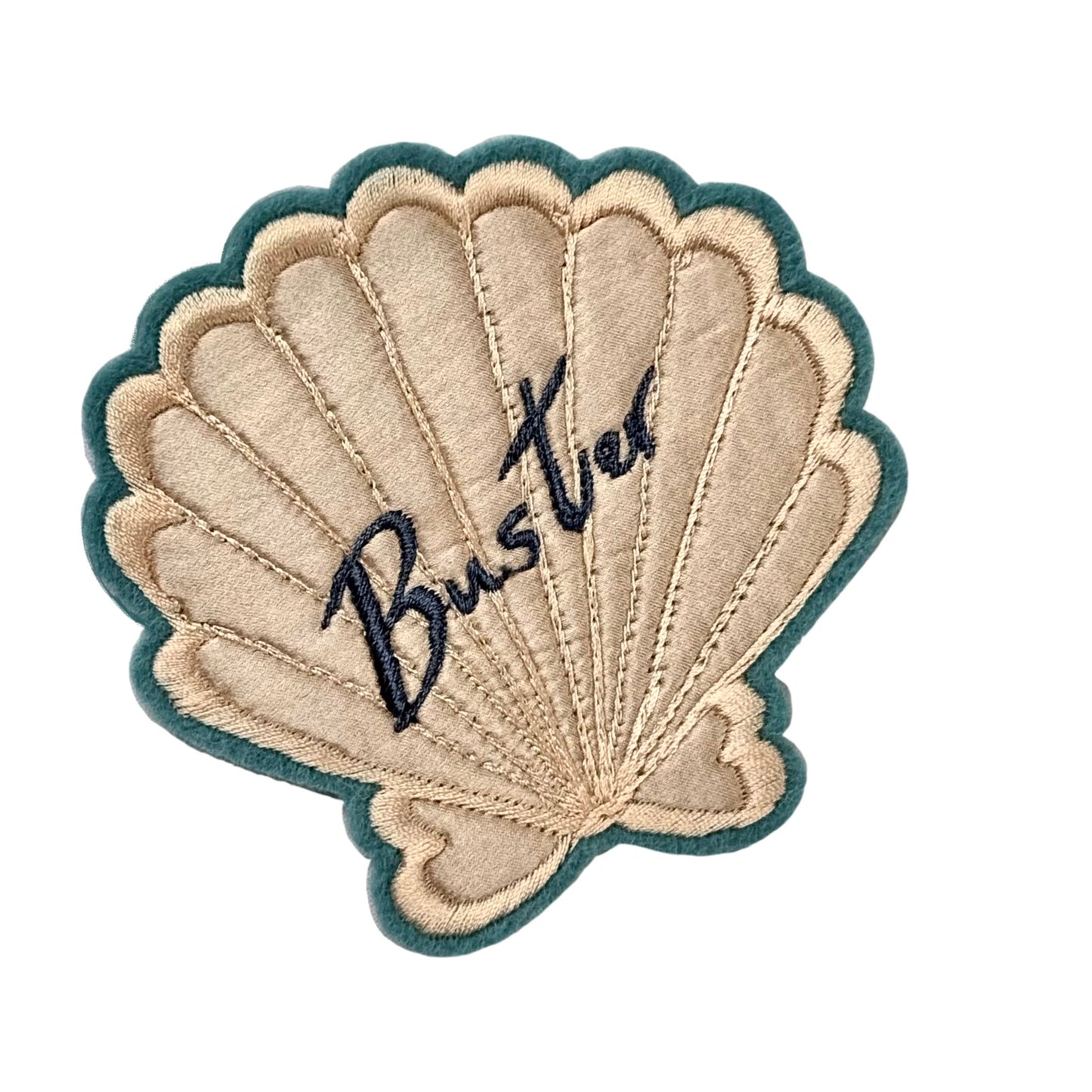 Silk applique shell patch on a white background. Has the word 'Buster' embroidered in blue on the shell.