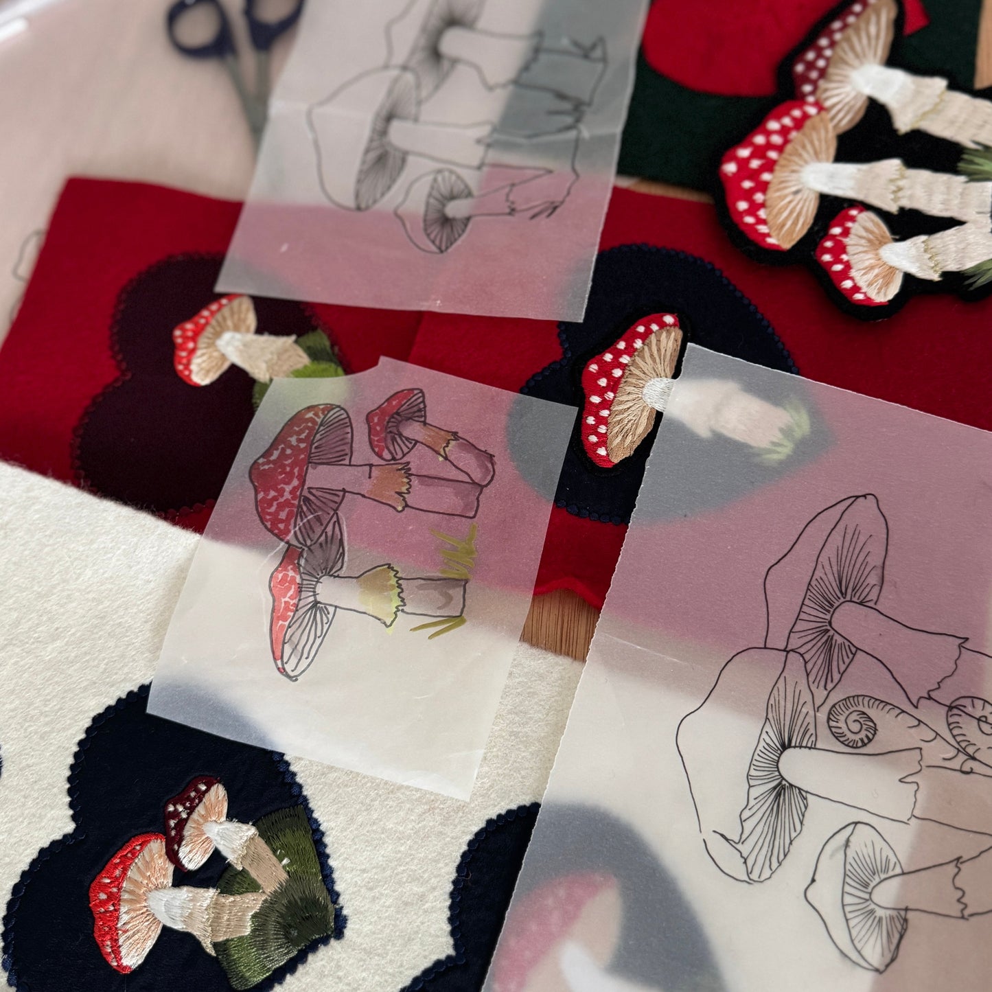 Transfers with mushroom designs on a red fabric background