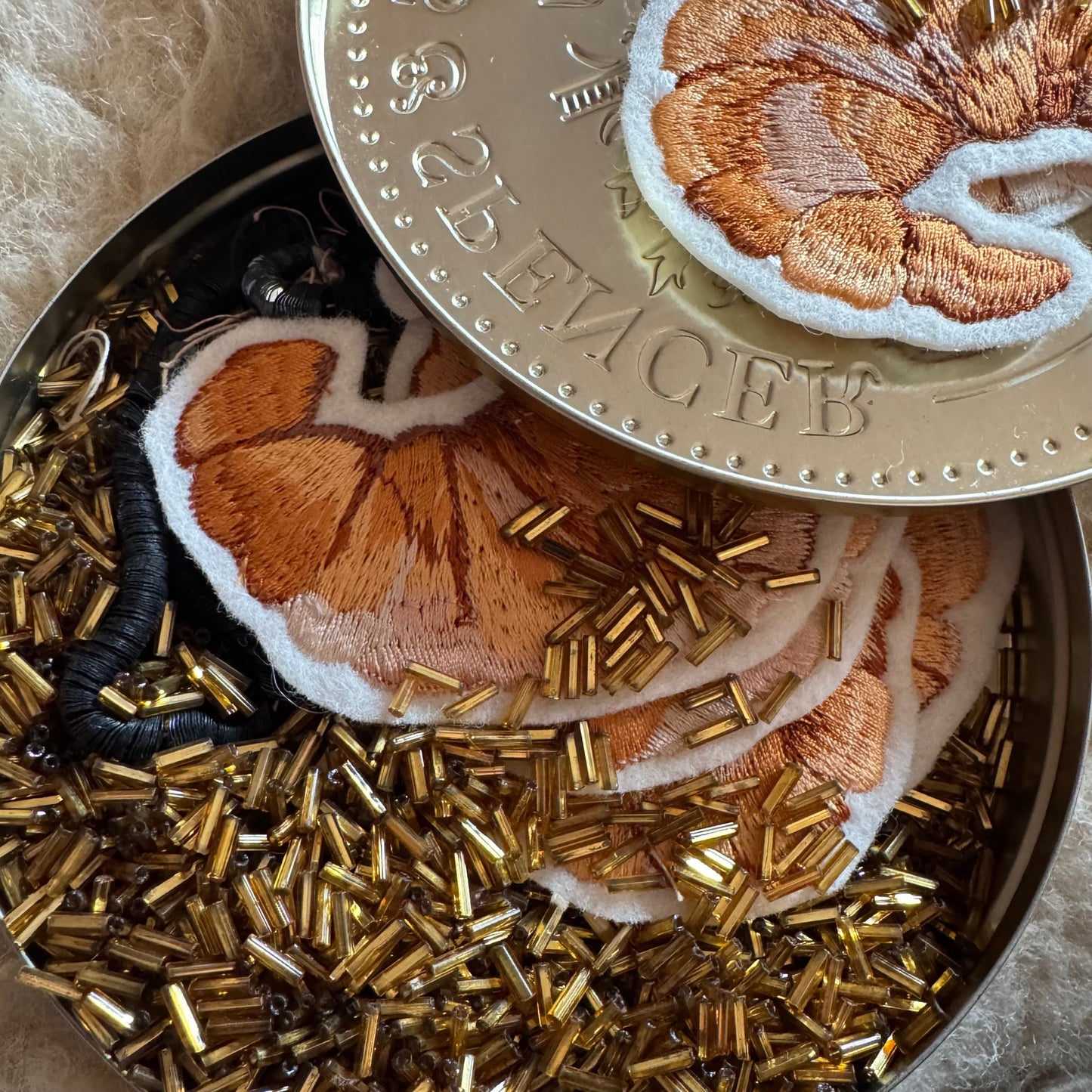 Croissant patch with tin of antique beads