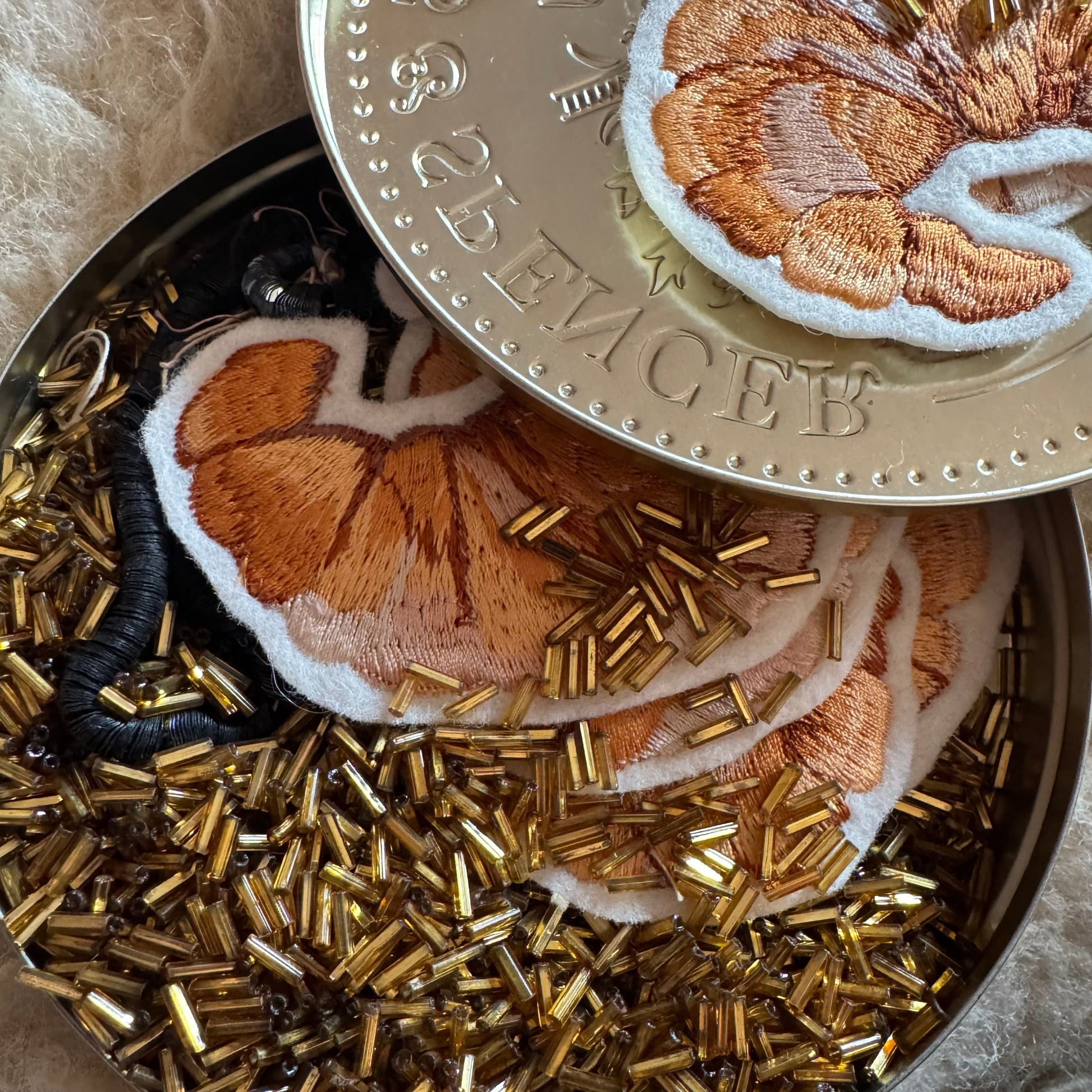 Croissant patch with tin of antique beads