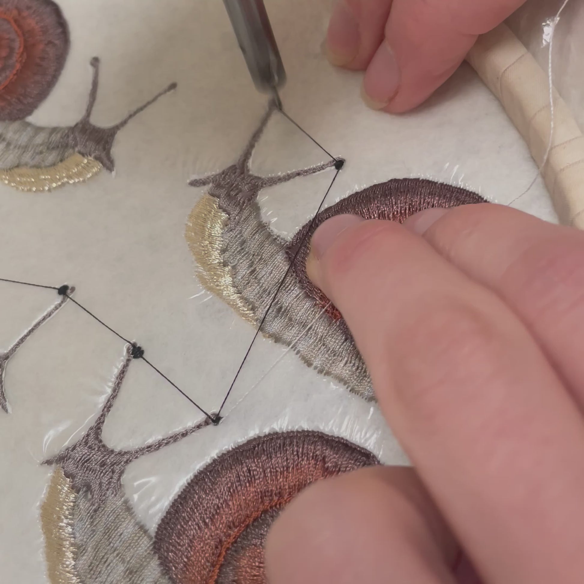 embroidering the snail patches eyes