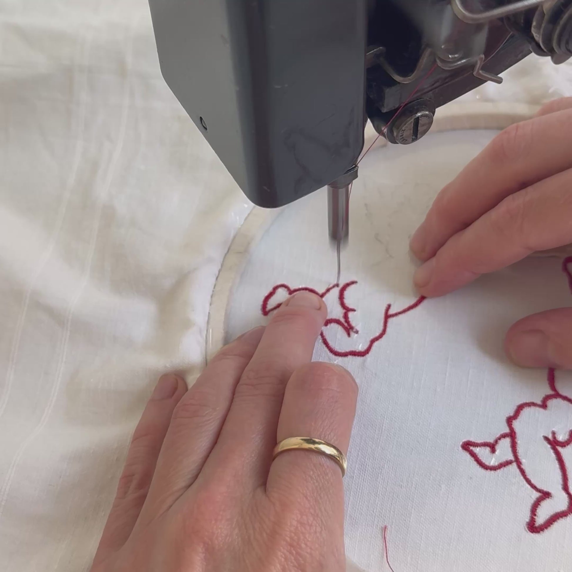 Video of Ellie Mac's hands embroidering the butter babies design on a vintage singer sewing machine
