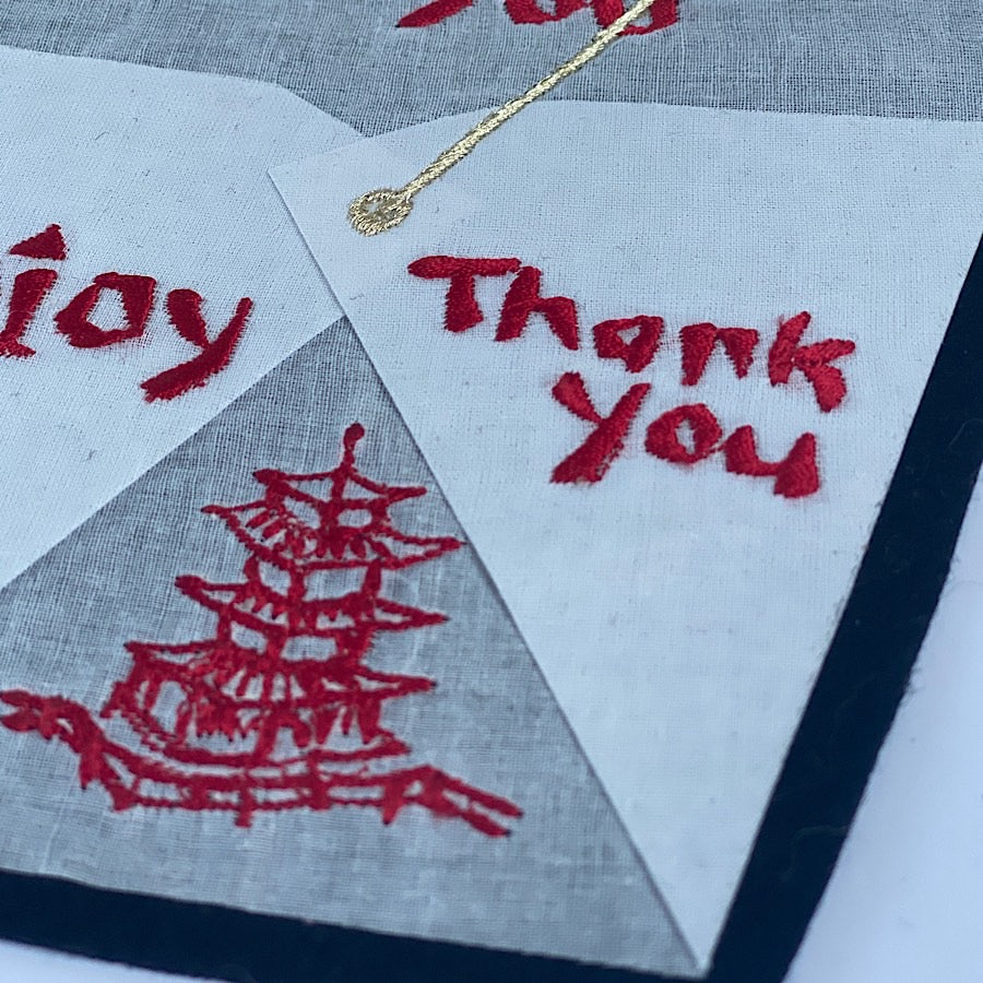 Close-up of origami takeaway box embroidered artwork