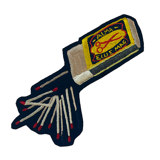Embroidered matchbox with the words 'Alma' and 'Ellie Mac' on and embroidered matches next to the box