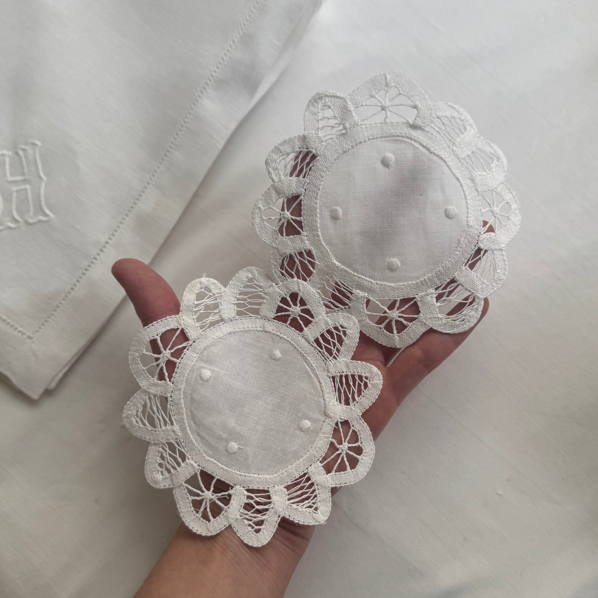 White lace doilies held in a hand 