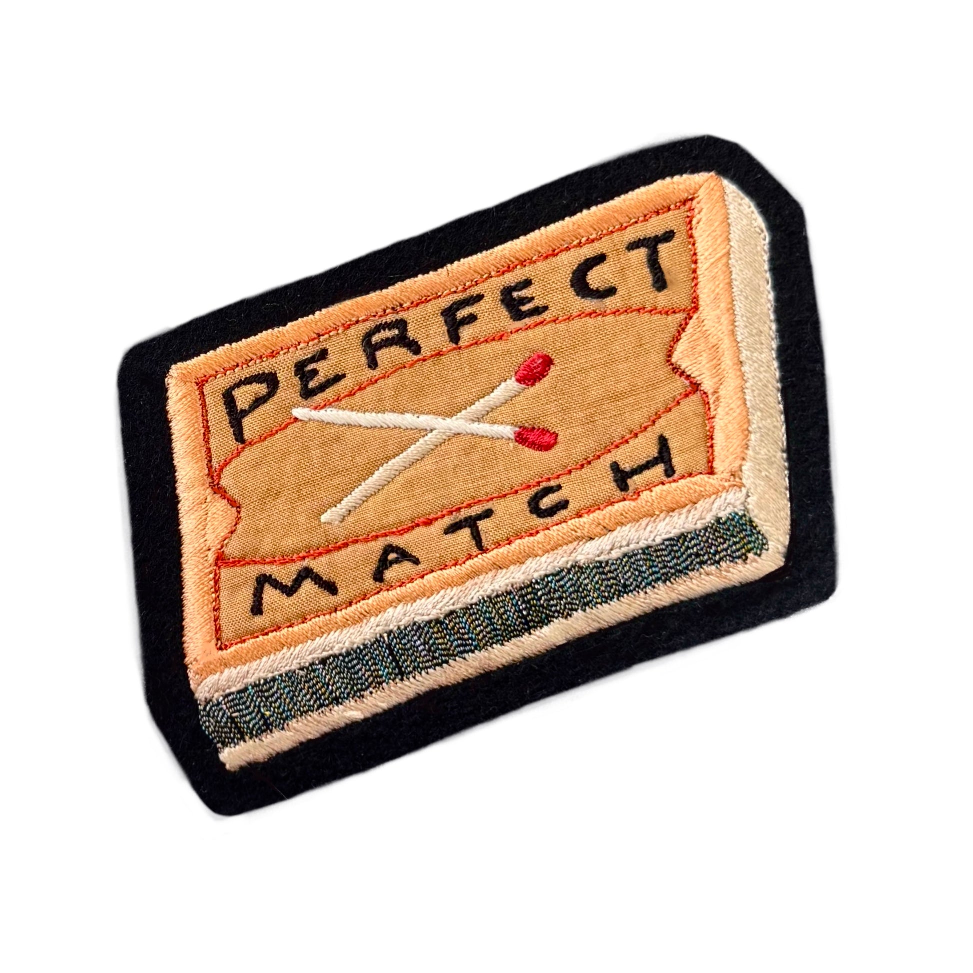 Embroidered 'perfect match' matchbox on white background