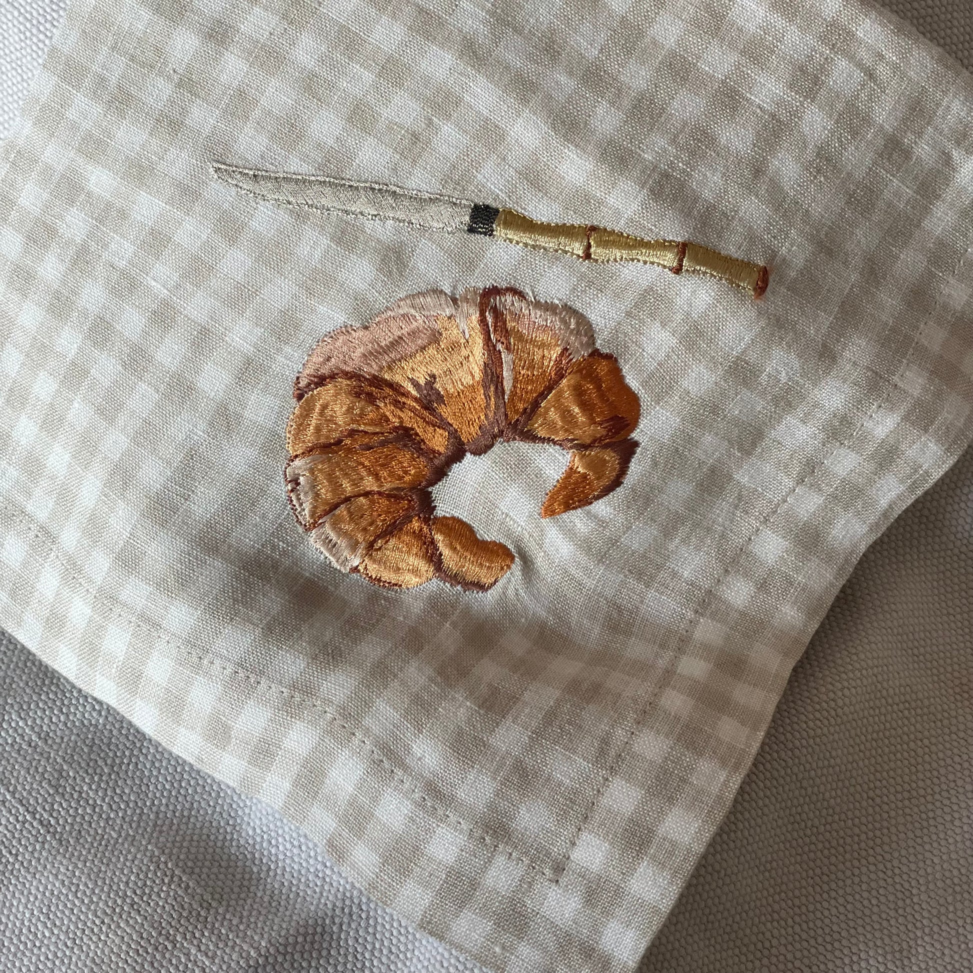 embroidered croissant on gingham napkin