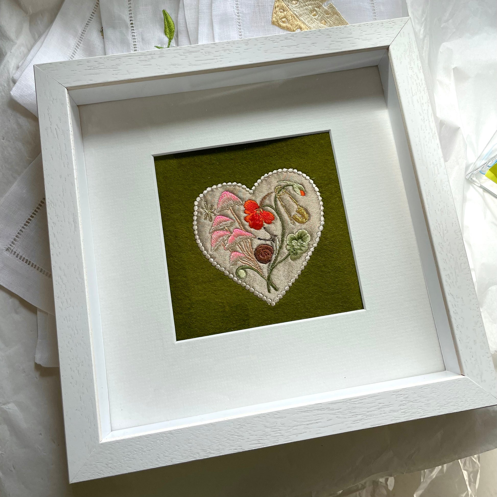 Silk applique garden embroidery shown in white box frame