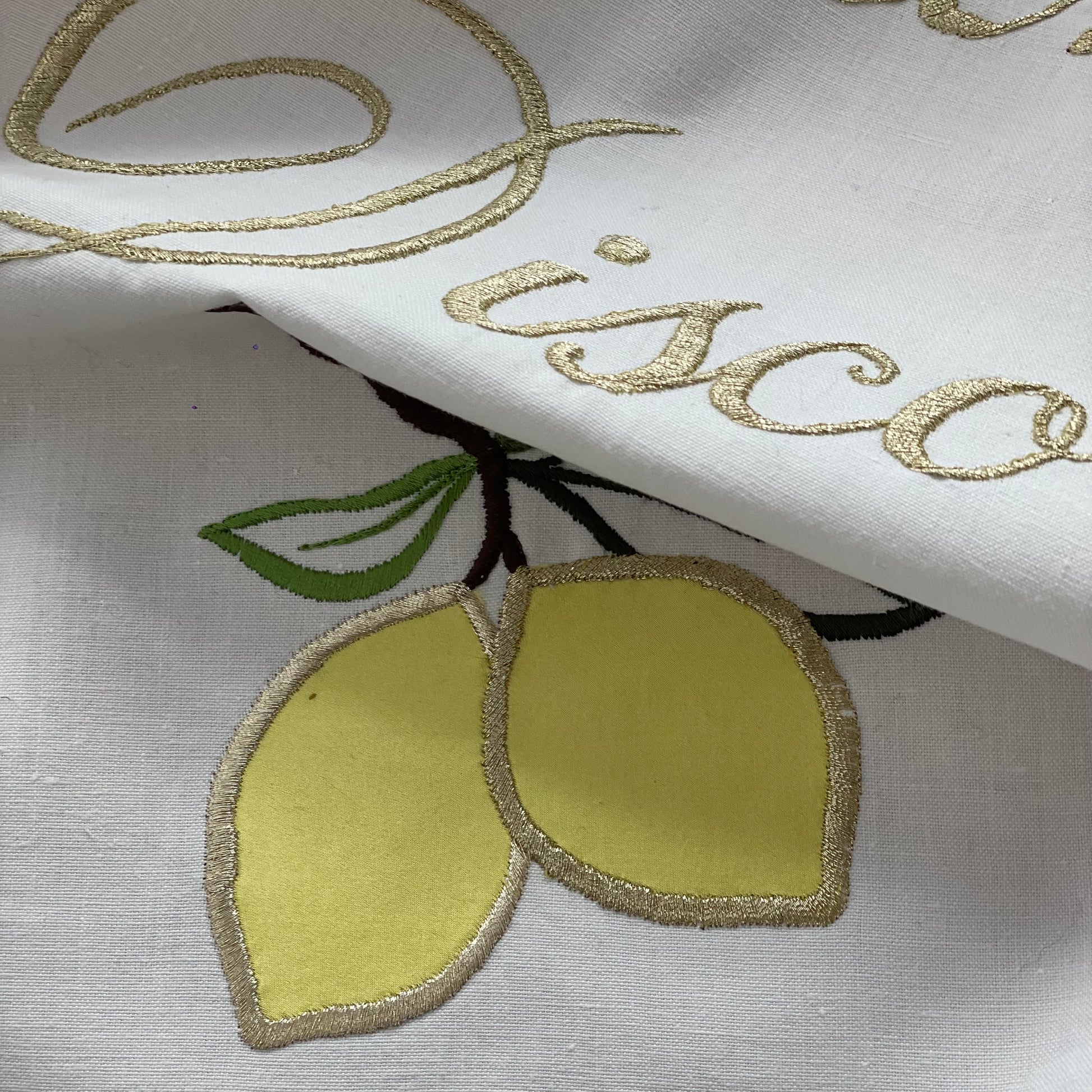 Close-up of Kitchen Disco Artwork showing embroidered lemons and the word 'disco'in gold thread