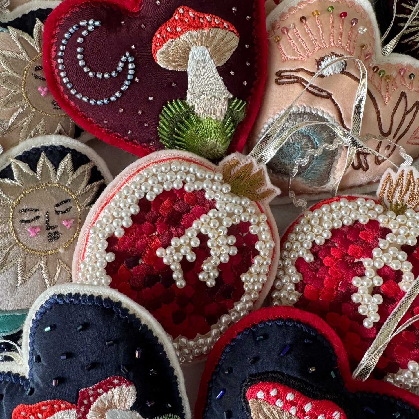 Collection of embroidered patches with various designs including mushrooms and floral patterns.