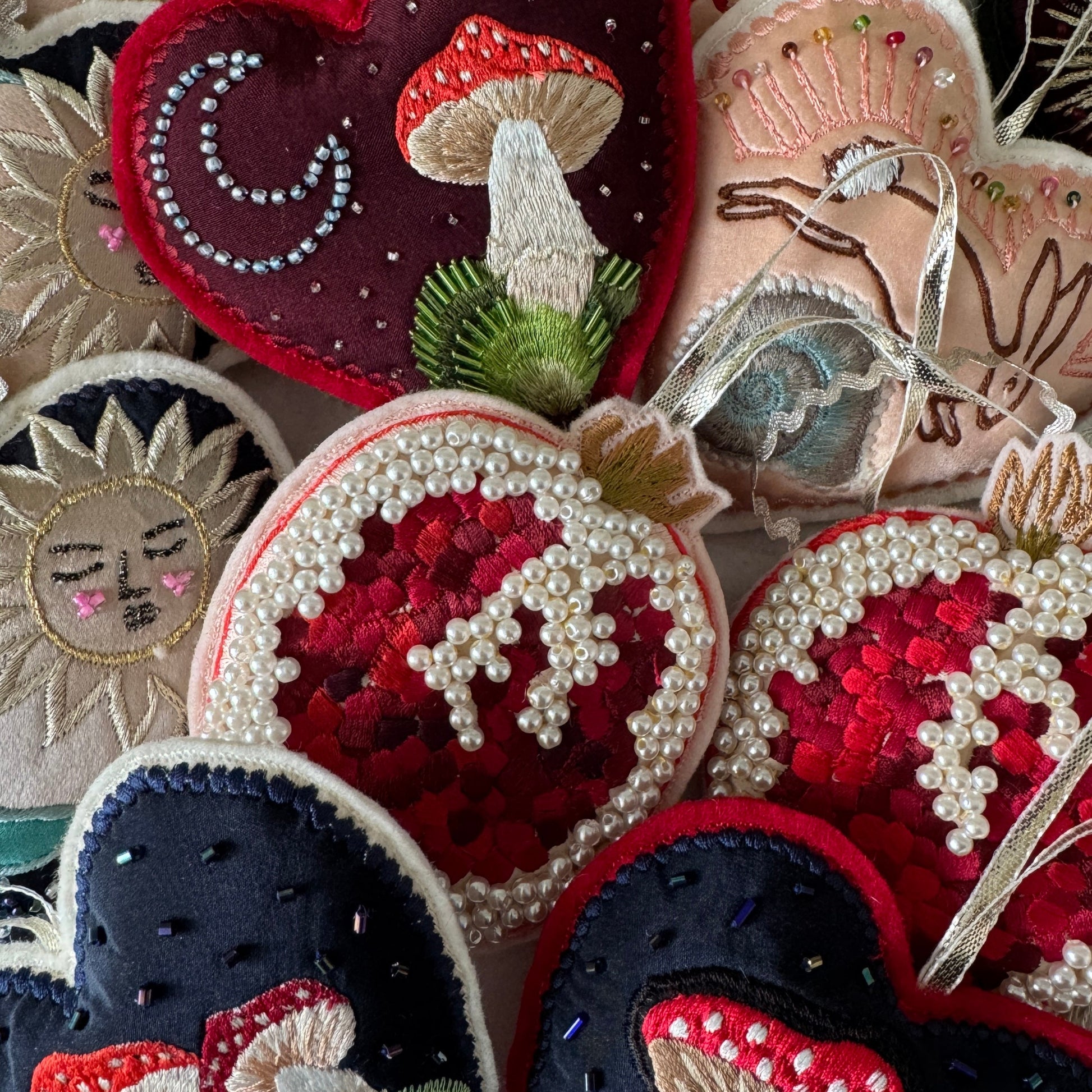 Collection of embroidered patches with various designs including mushrooms and floral patterns.