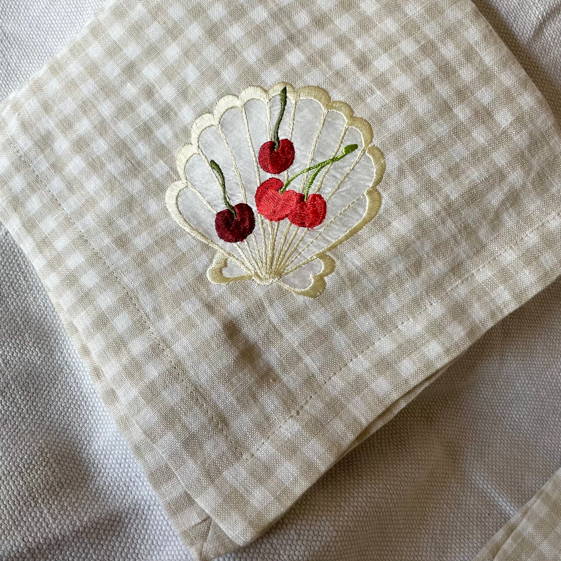 silk applique shell with embroidered cherries on gingham napkin