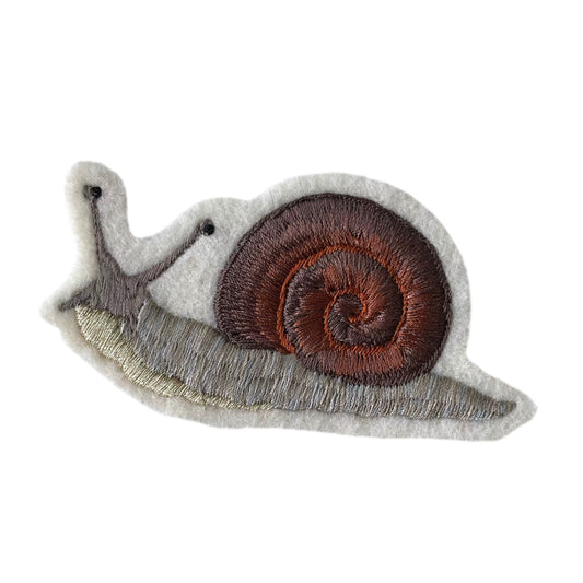 embroidered snail patch on white background