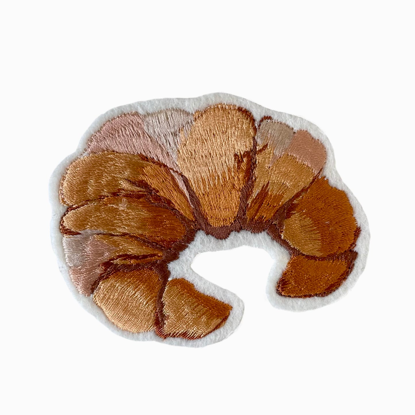 Croissant embroidered patch on white background