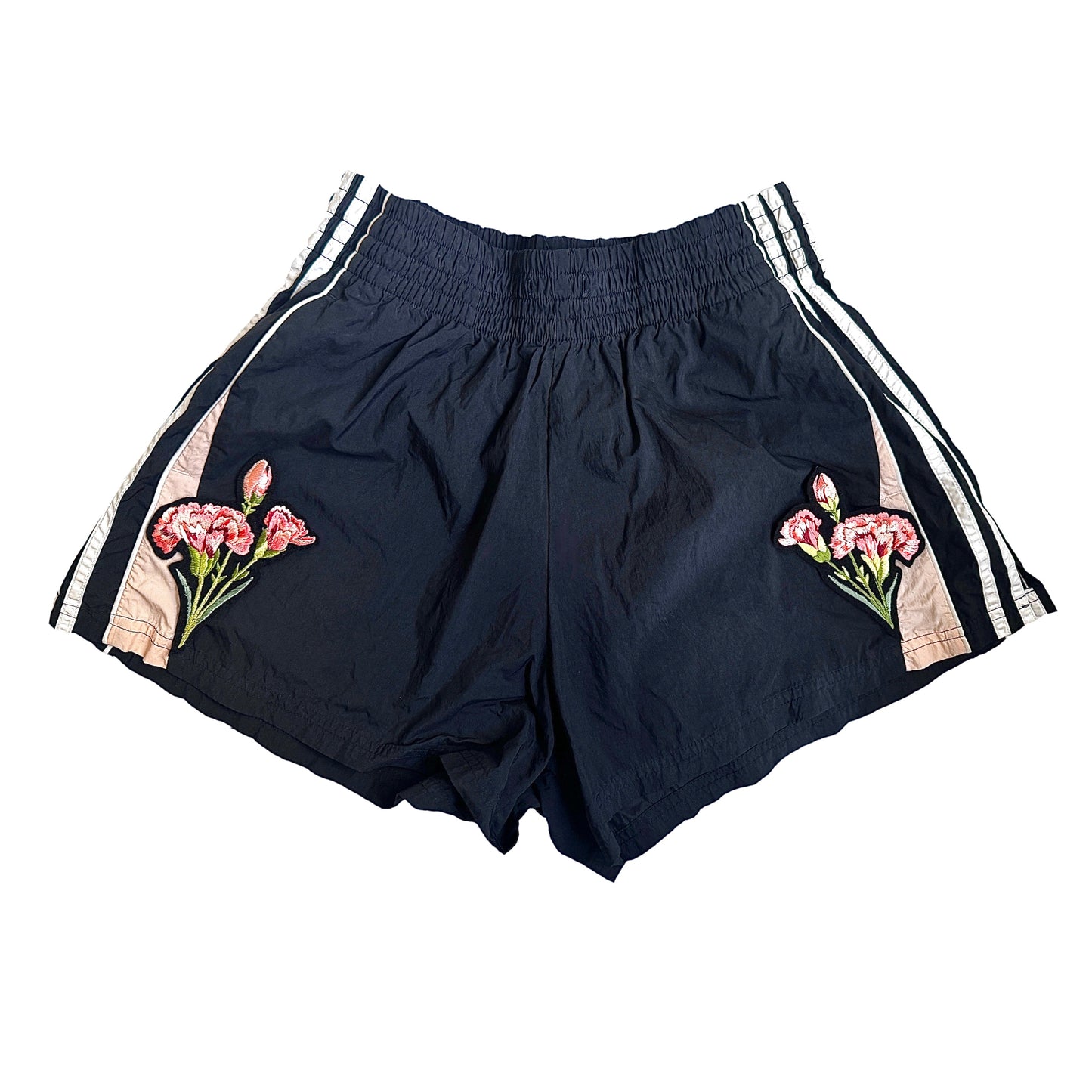 Black shorts with floral designs on a white background