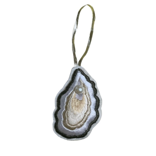 Embroidered oyster decoration with pearl on a white background