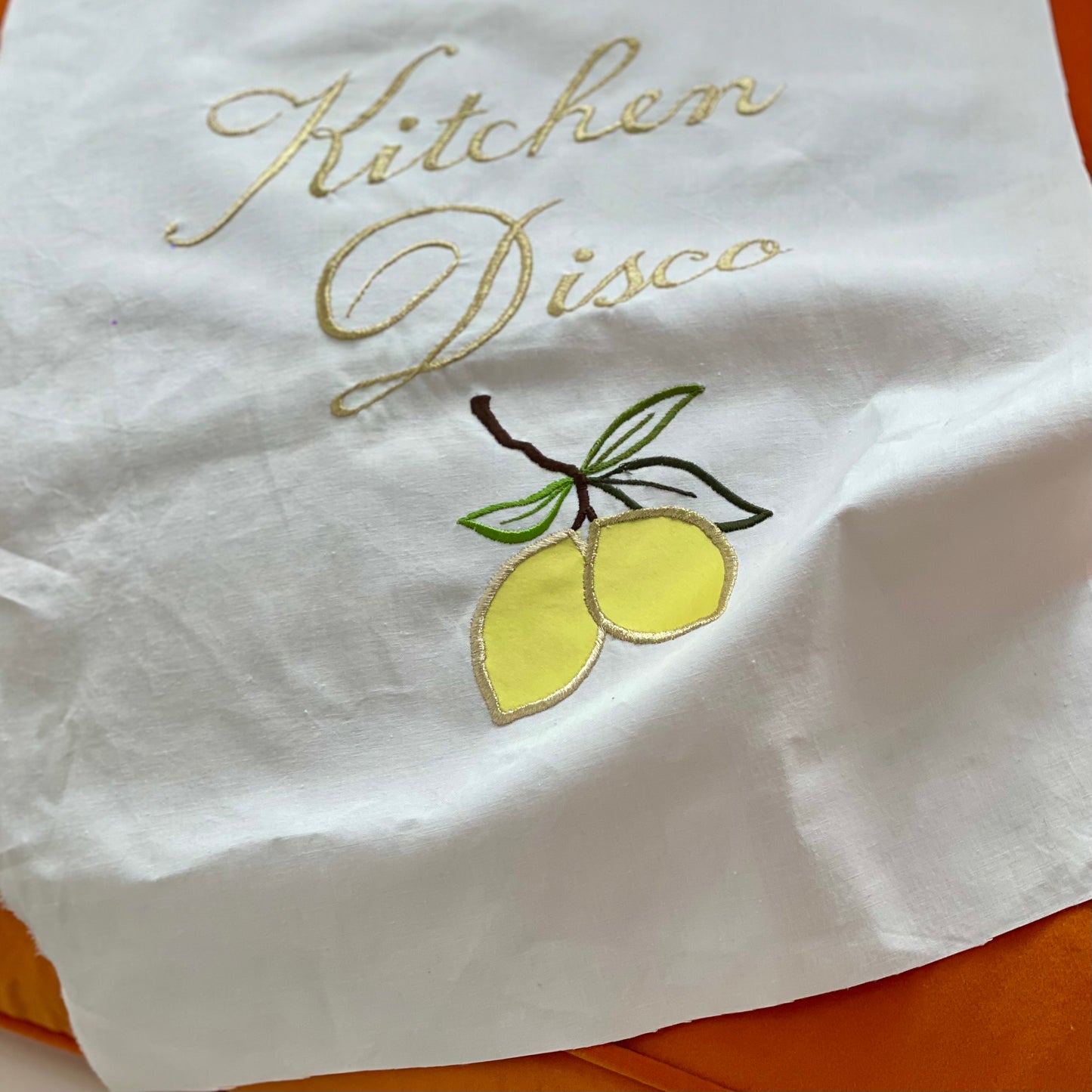 Close-up of Kitchen Disco Artwork with embroidered lemons and text seen