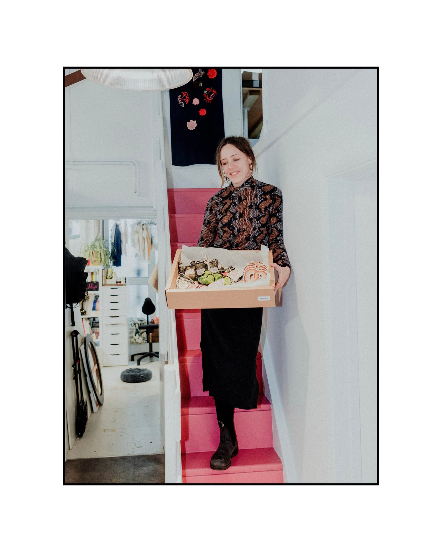 Ellie Mac Embroidery at her studio with a tray of embroidered pieces