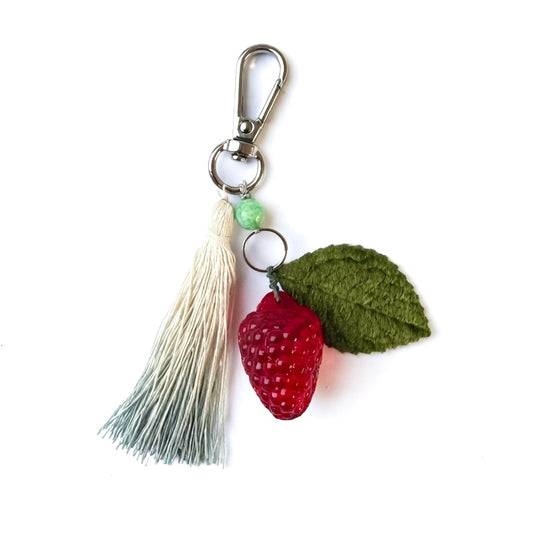 Keychain with raseberry and leaf design on a white background