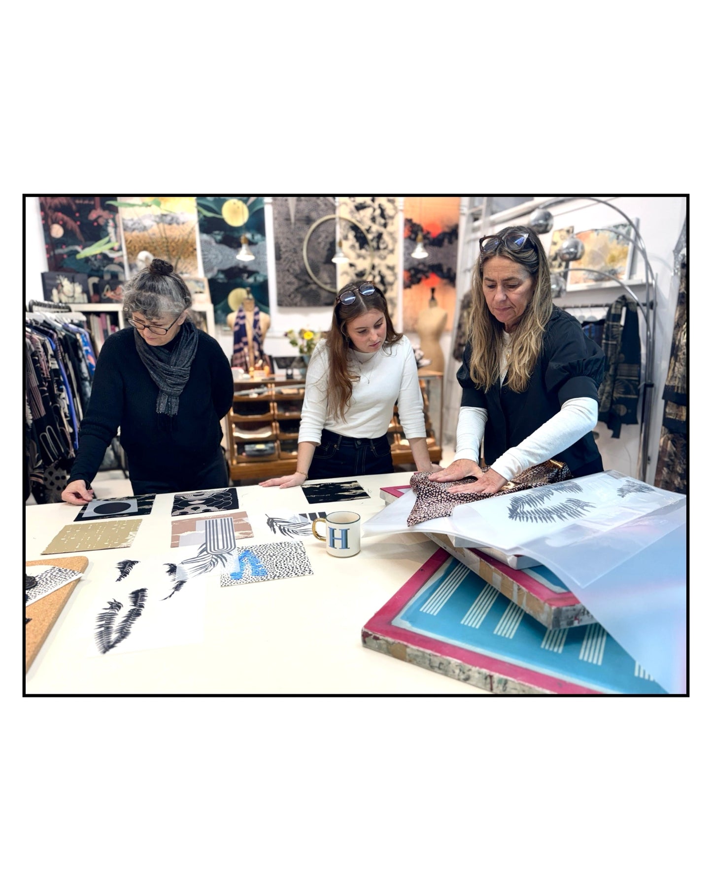 Sophie Darling looking at fabric samples in studio