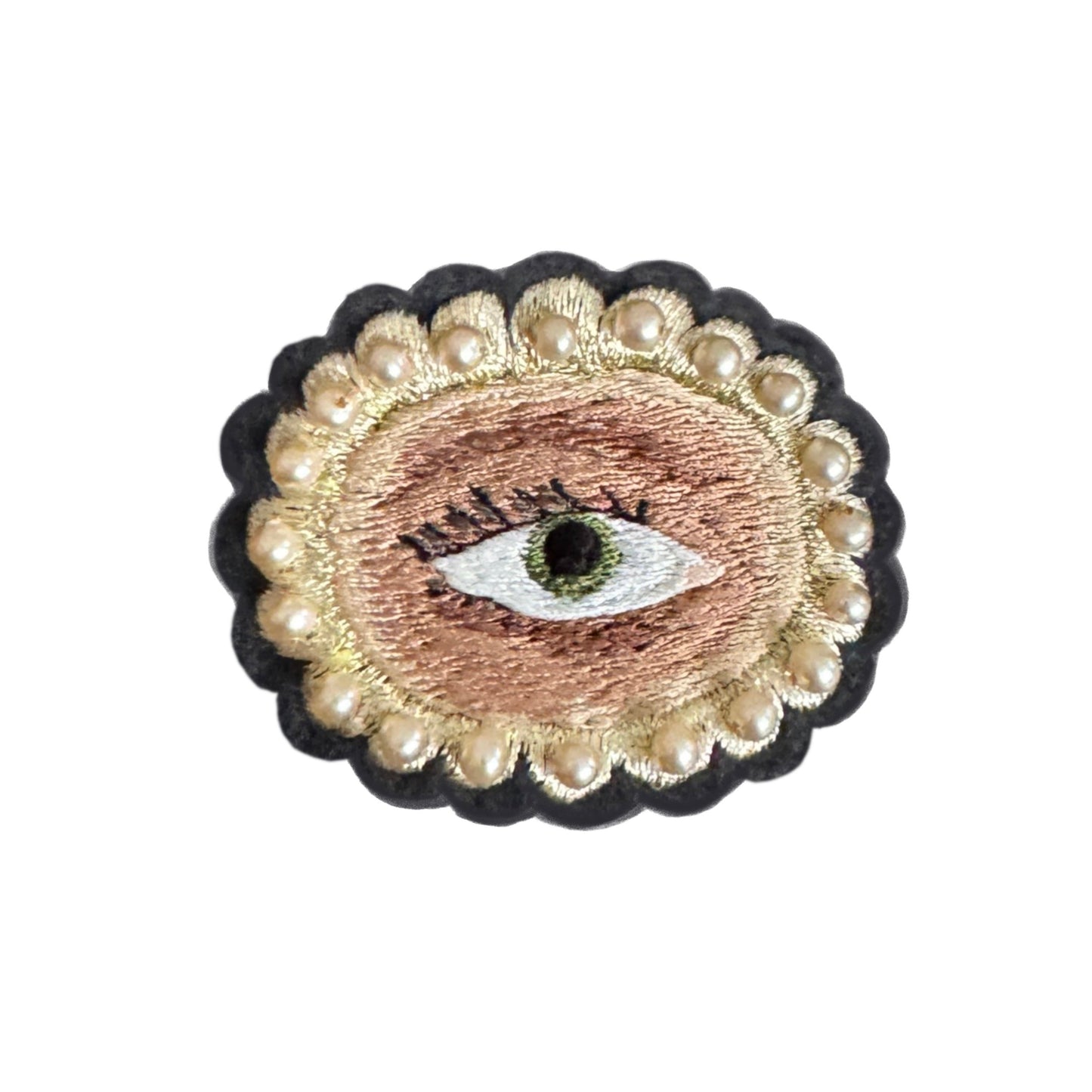 Embroidered patch with an eye design surrounded by pearls on a white background