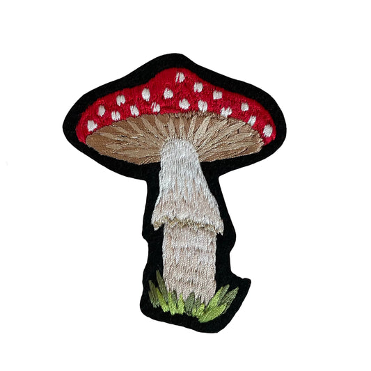 Embroidered mushroom patch on white background