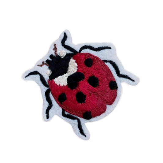 Small ladybird embroidered patch on white background