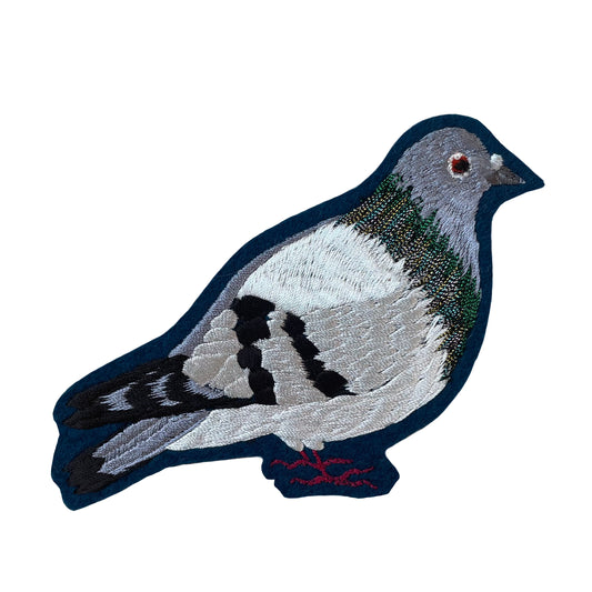 Pigeon embroidered patch on white background