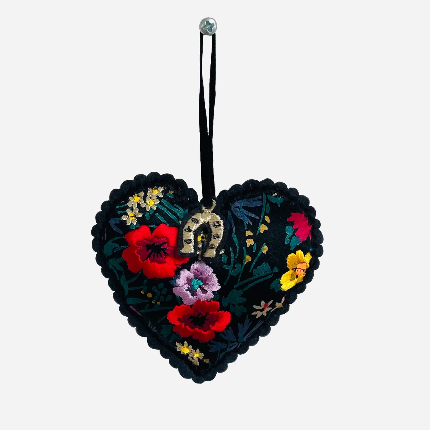 Embroidered padded silk heart on white background