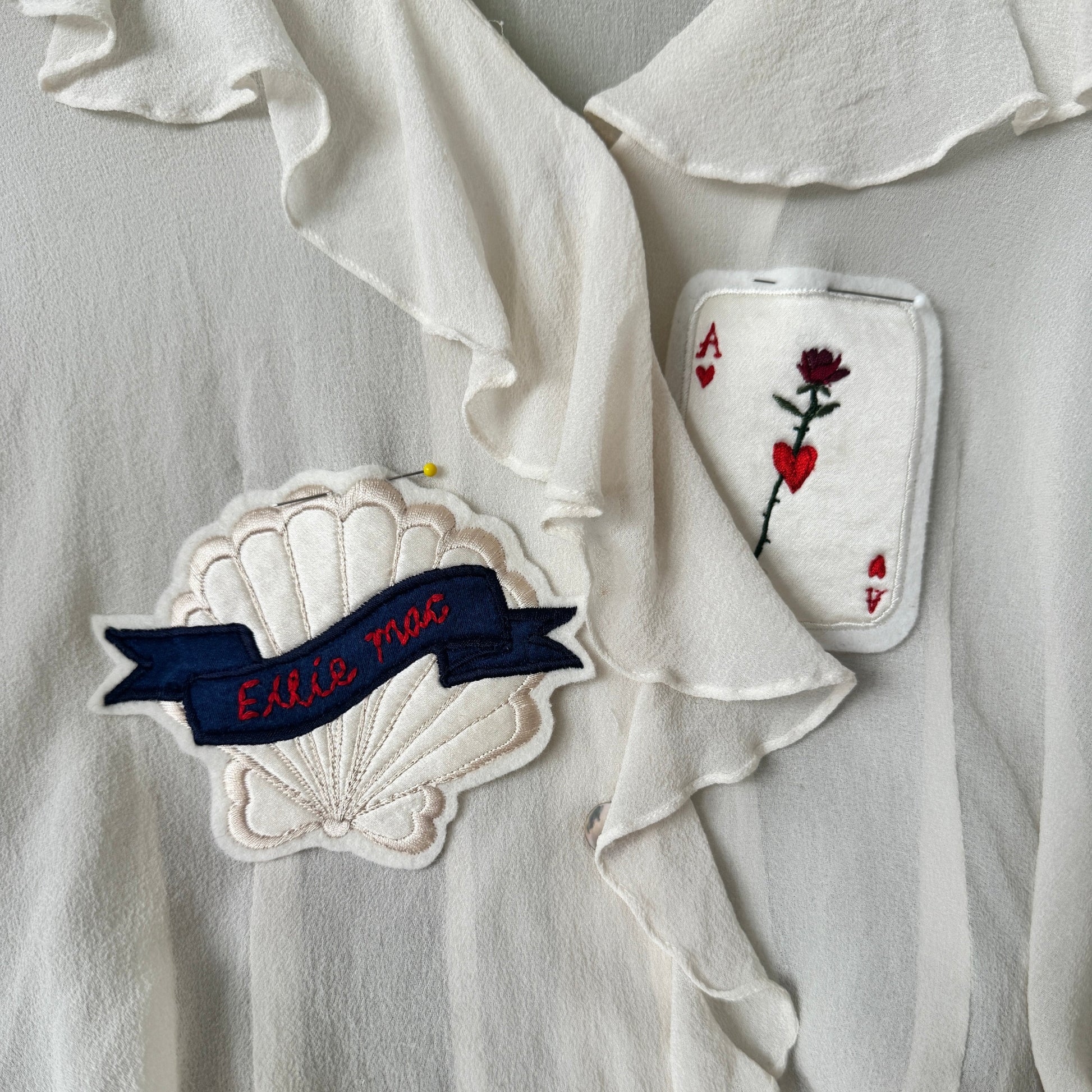 Embroidered patches on a white blouse background
