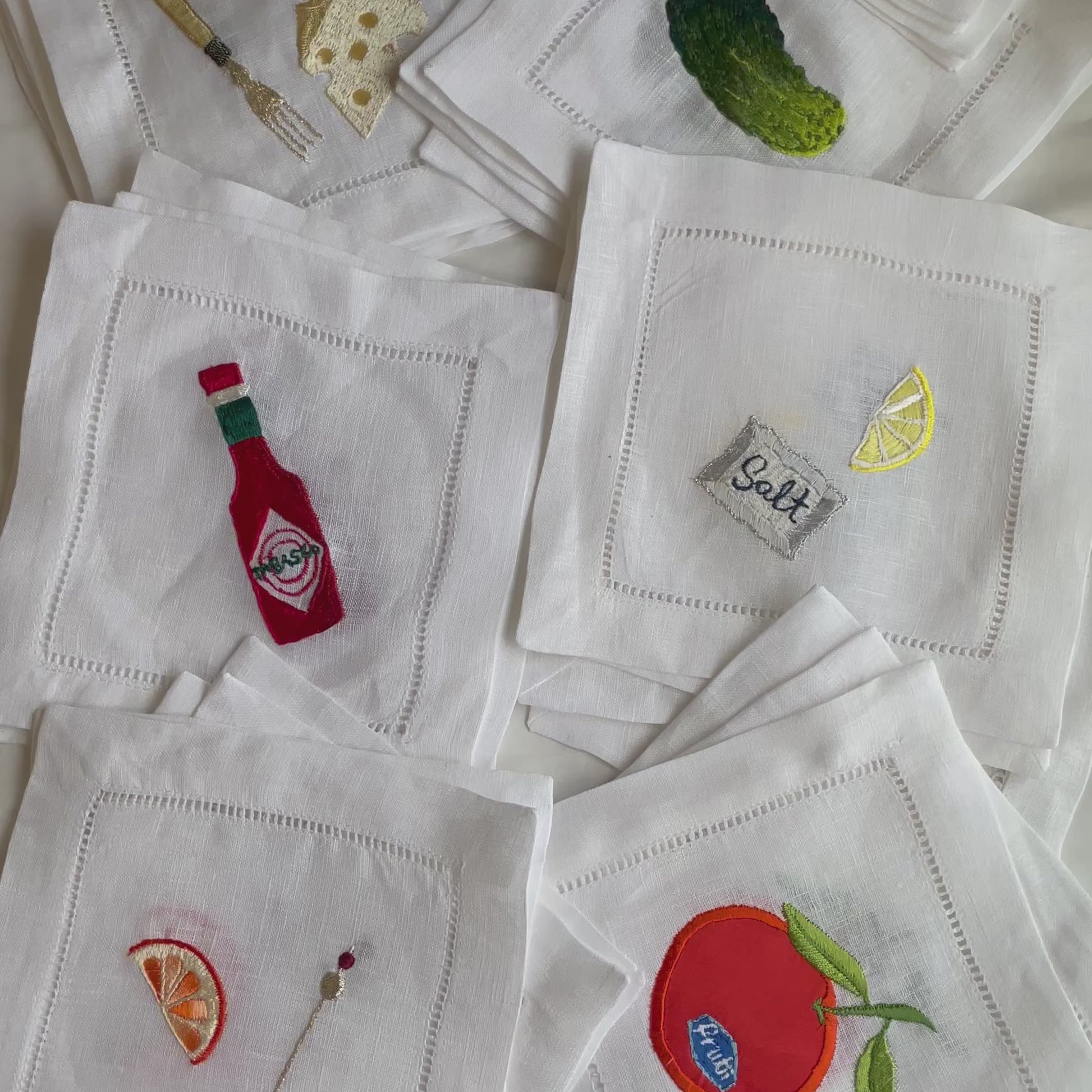 Video of the stacks of the different designs of embroidered linen drinks coasters