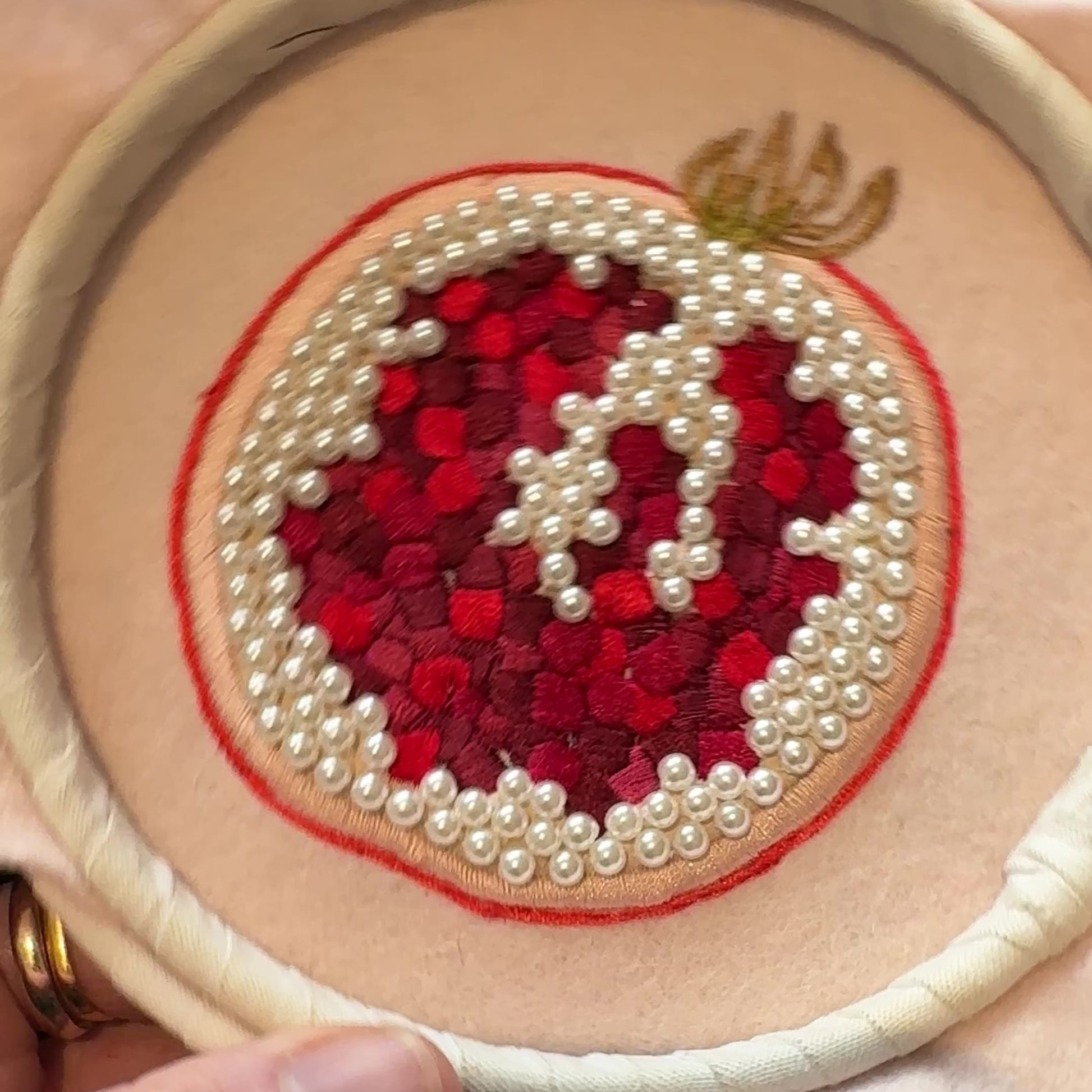 Beaded pomegranate in an embroidery hoop