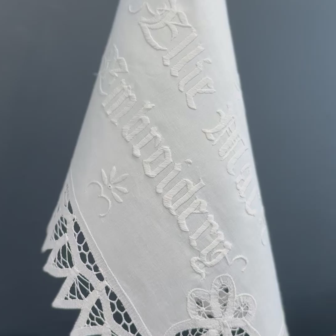 video of vintage linen with white embroidered text