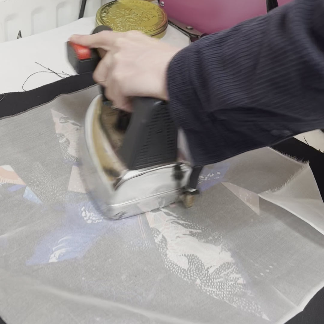 Video of a hand ironing one of the finished embroidered cushions