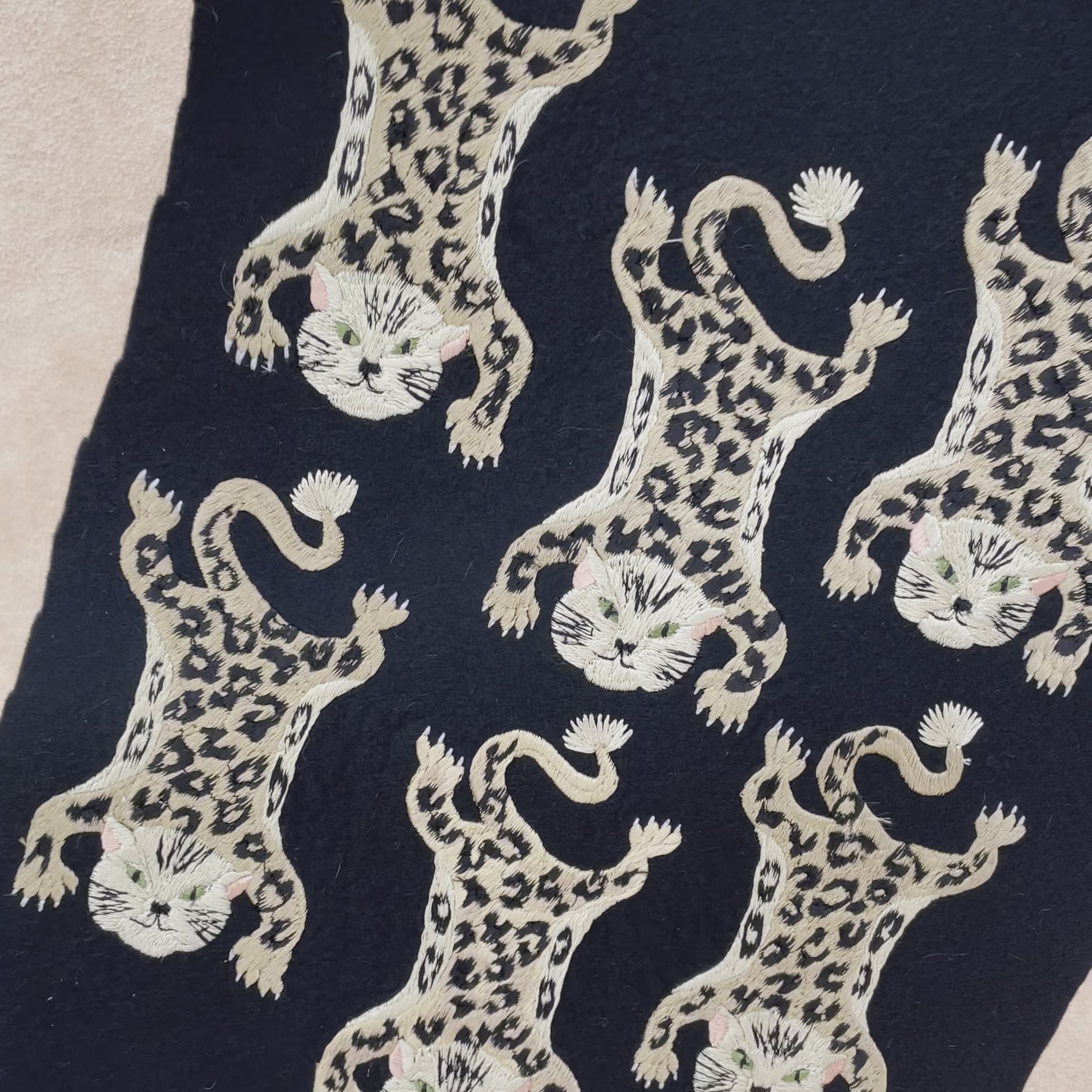 Leopard embroidered patches shown before being cut-out on black felt