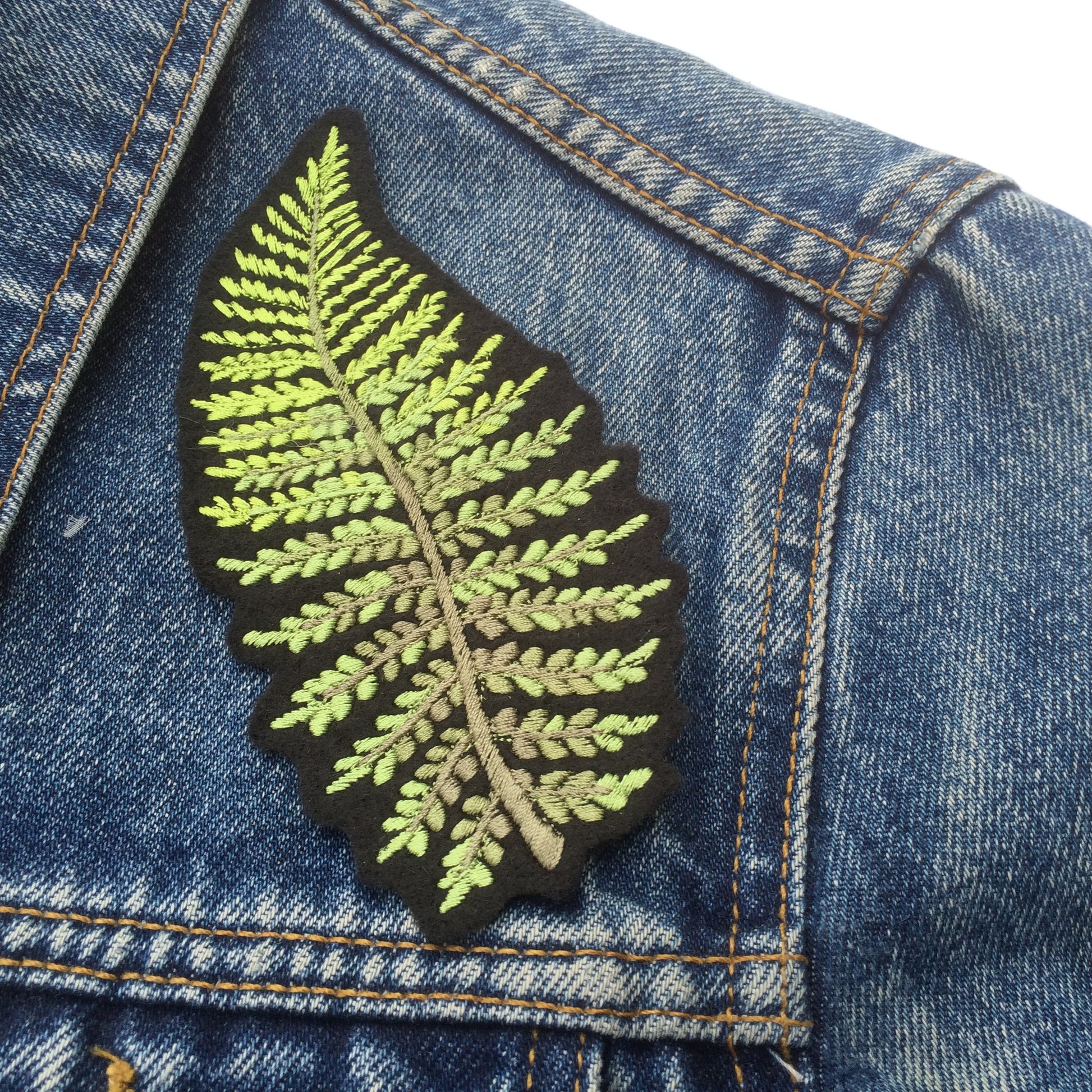 Fern embroidered patch shown on shoulder of denim jacket