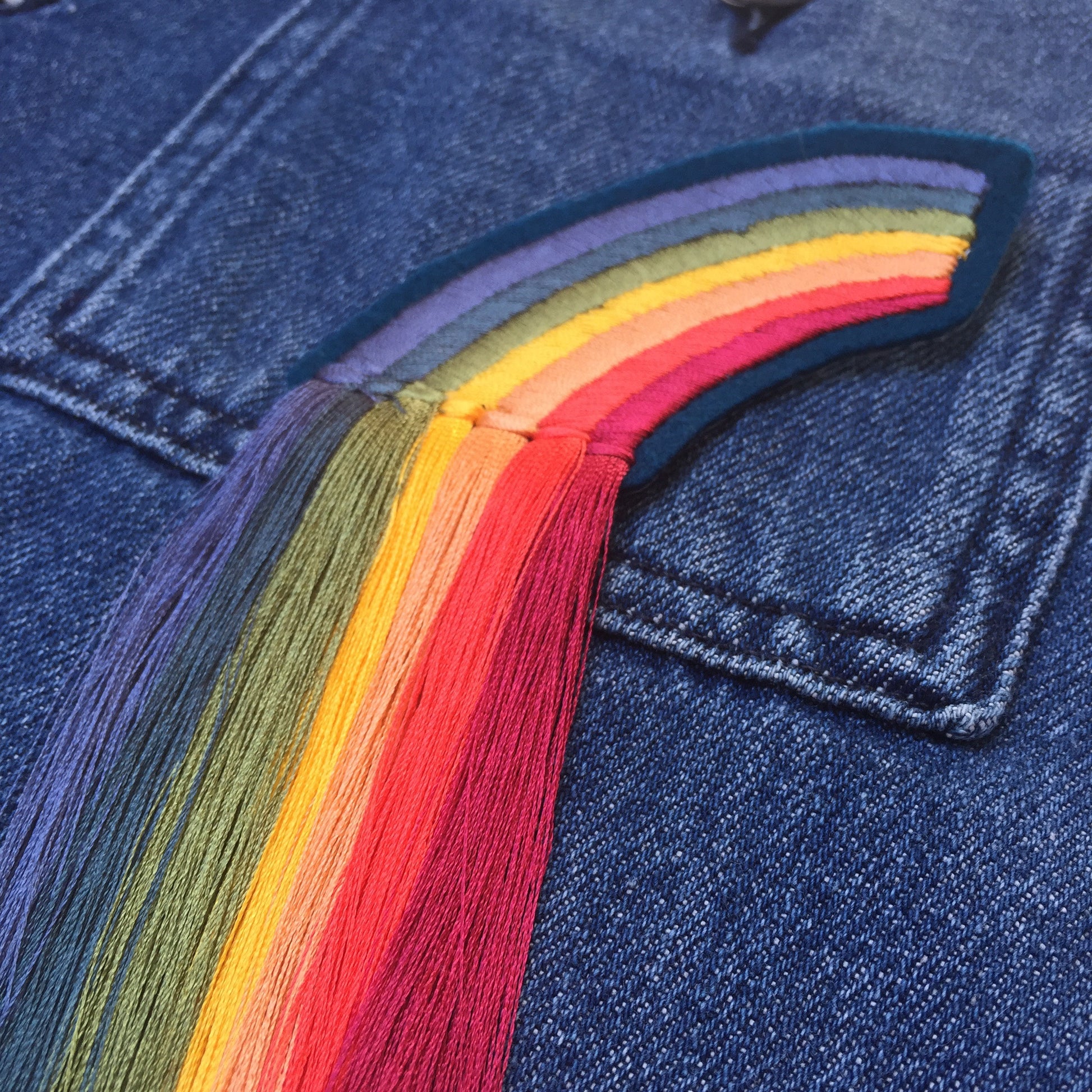 Close-up of fringed rainbow embroidered patch