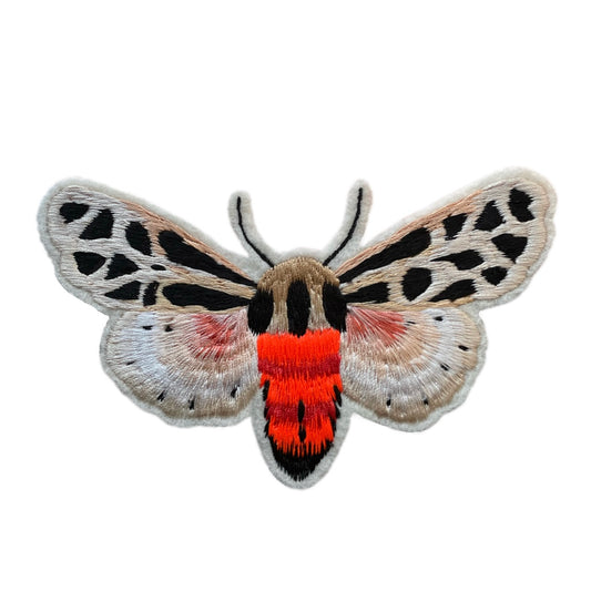 neon tiger moth embroidered patch on white background