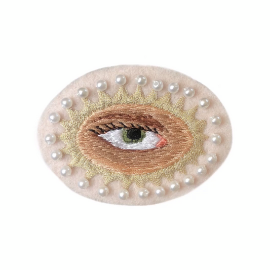 Lover's eye embroidered patch with green iris on white background