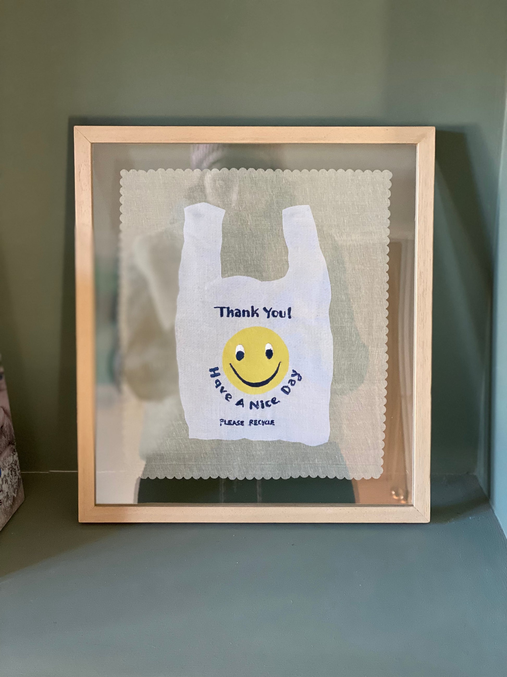 Have a nice day embroidered artwork framed in a wood and glass picture frame