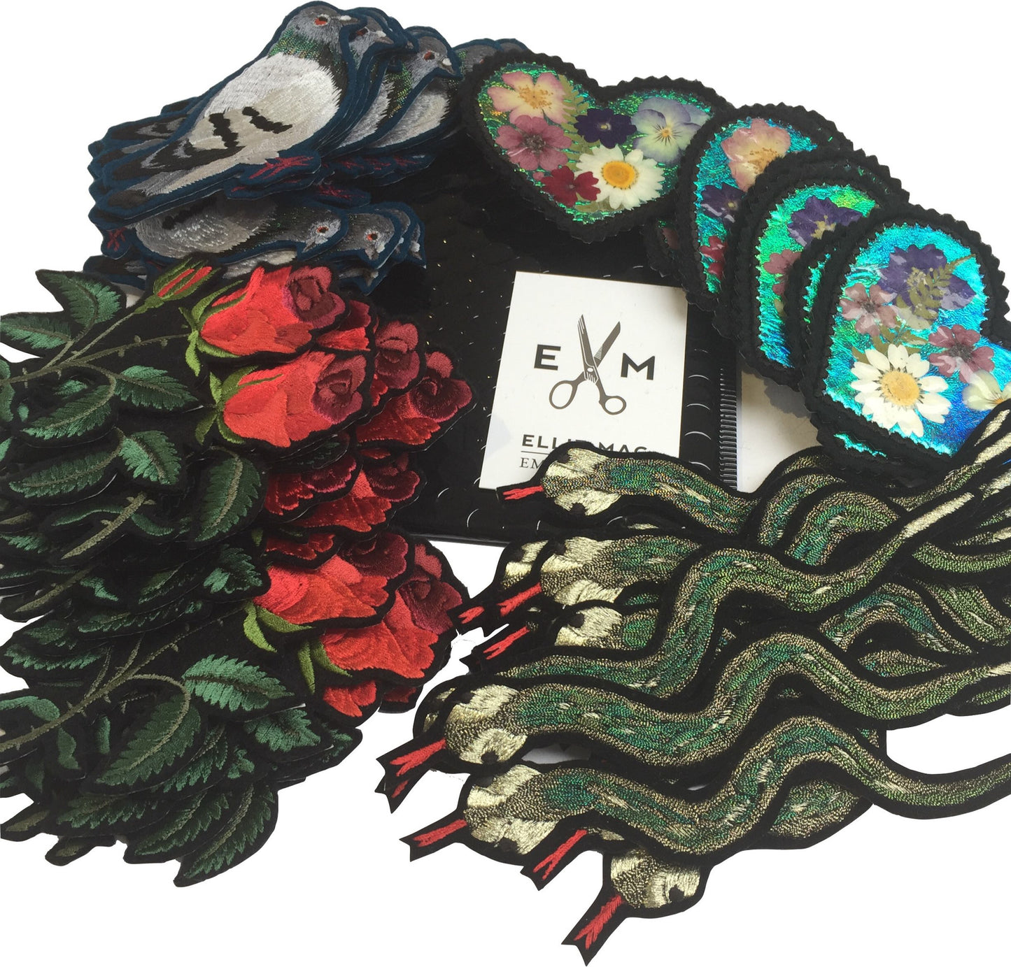 Collection of Ellie Mac embroidered patches including a metallic snake, pigeon and the red rose