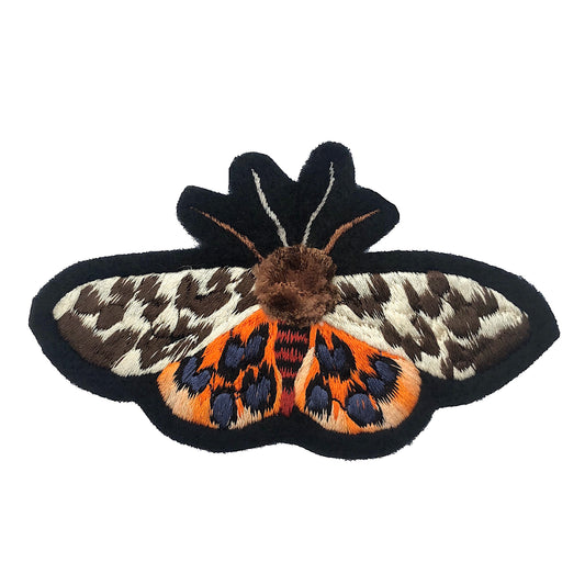 Pom-pom tiger moth embroidered patch on white background