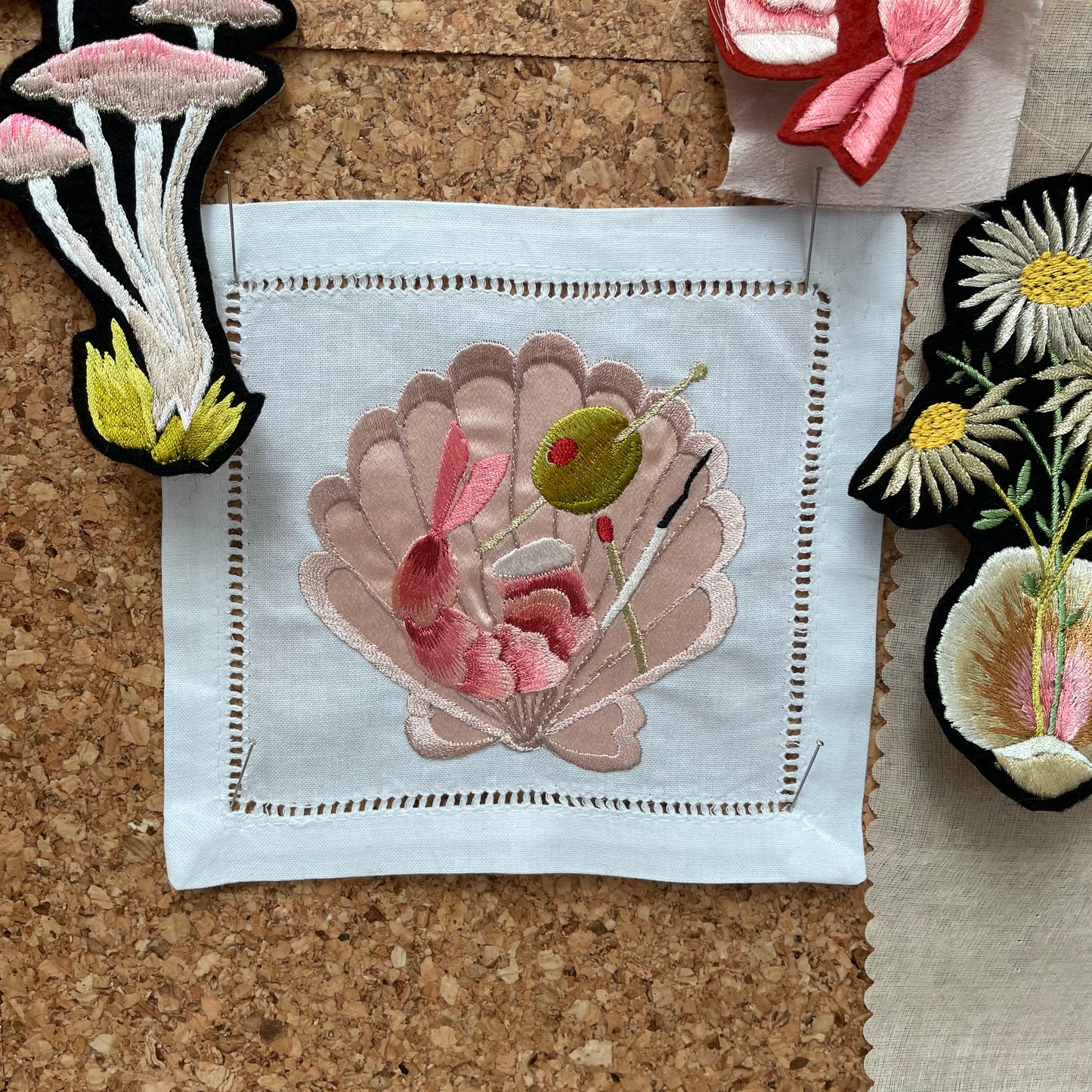 Embroidered Napkin by Ellie Mac Embroidery Pinned To Corkboard