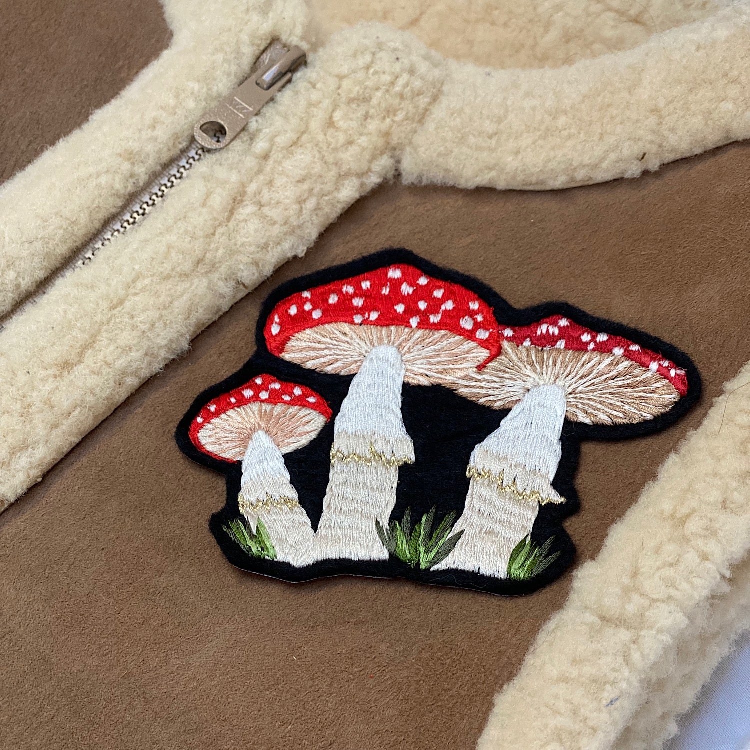 Embroidered mushroom patch on an item of clothing