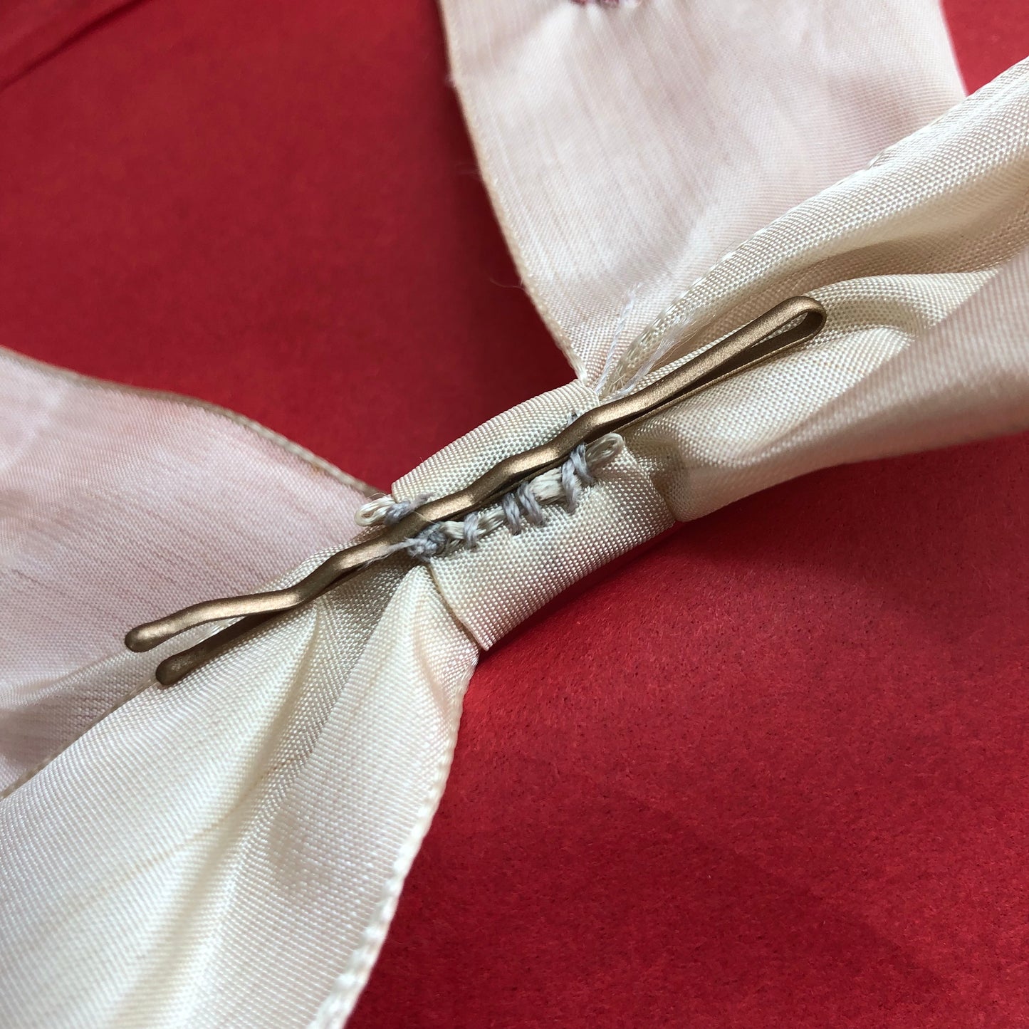 Close-up of hand sewn hair grip on the back of the vintage ribbon strawberry hair bow