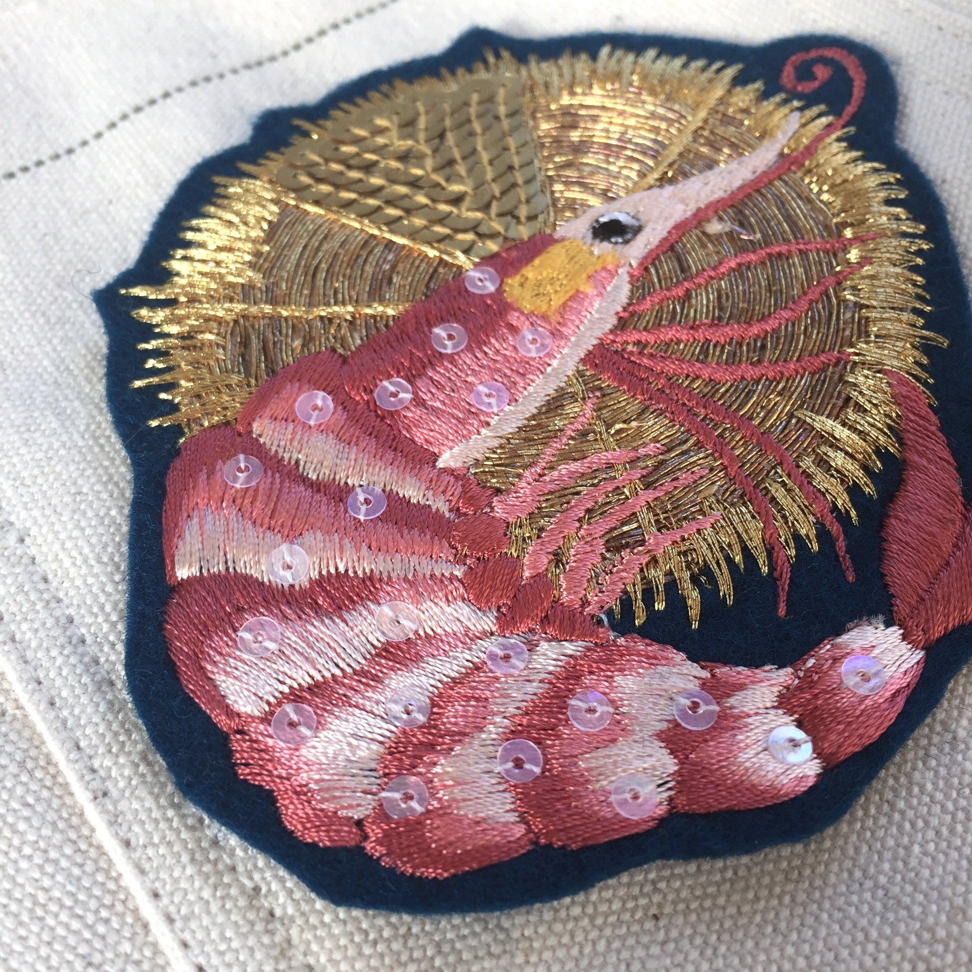Close-up details of luxe king prawn embroidered patch
